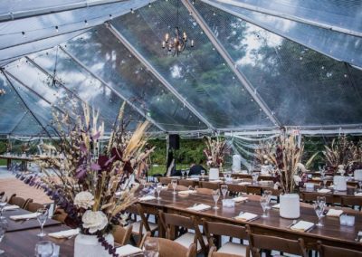 food set up under a clear top wedding tent