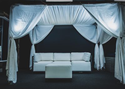 a lounge area set up under a wedding tent
